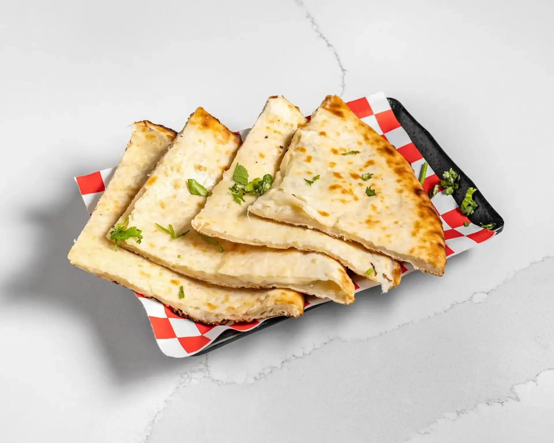 Fresh naan bread with authentic curries at Twist of TAJ Nolan Hill